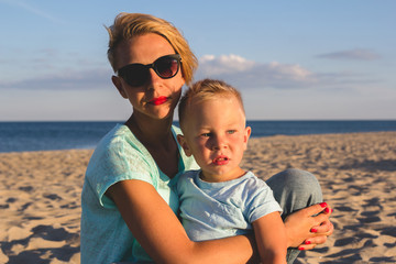 Happy family resting at beach in summer