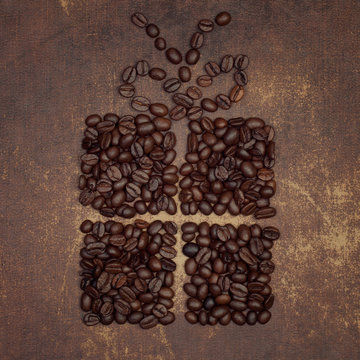 The shape of a present with a bow on top made out of a dark roas