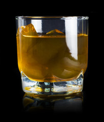 Glasses of brandy in cellar with old barrels