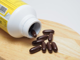 Many tablets of food supplements with bottle.