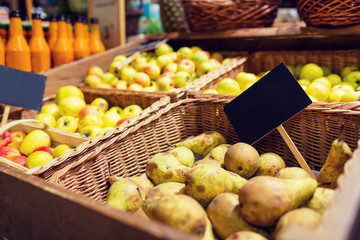 fruits in baskets with nameplates at food market