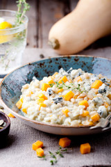 Pumpkin, blue cheese risotto in a ceramic plate 