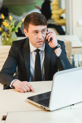 Attentive businessman writing on notebook at office