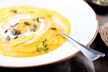 Pumpkin soup with cream, seeds and thyme 