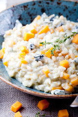 Pumpkin, blue cheese risotto in a ceramic plate 