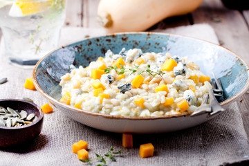 Pumpkin, blue cheese risotto in a ceramic plate 
