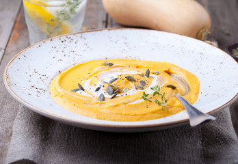 Pumpkin soup with cream, seeds and thyme 