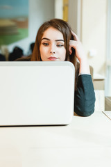 Young businesswoman on a coffee break. Using tablet computer.