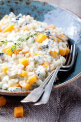 Pumpkin, blue cheese risotto in a ceramic plate 