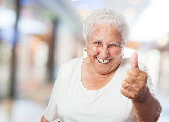 happy old woman with thumb up closeup