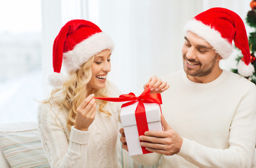 happy couple at home with christmas gift box