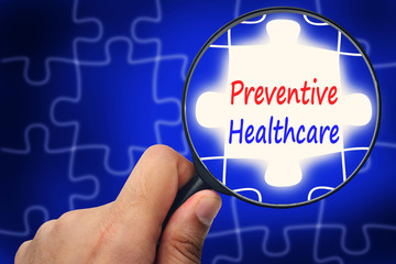 preventive health care word. Magnifier and puzzles.