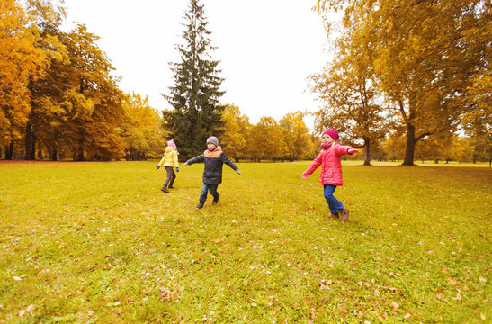 happy little children running and playing outdoors