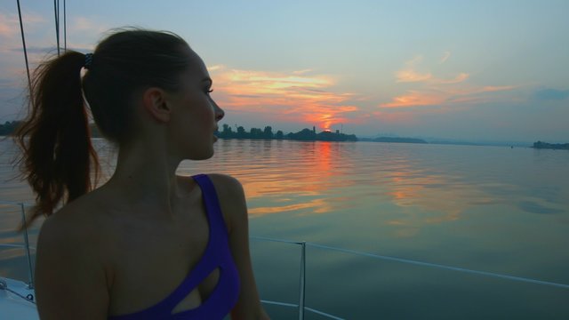 Girl enjoys traveling on the yacht.