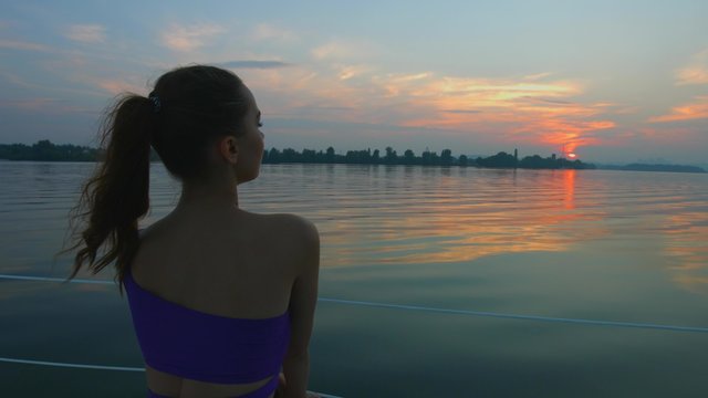 Girl enjoying the sunset on the river.