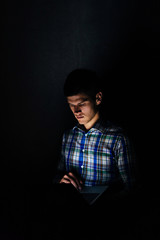 Dark portrait of it specialist with laptop