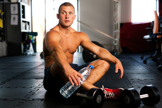 Young muscular man resting after gym workout