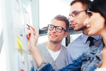 Colleagues discussing their results in front of a board