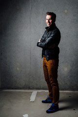 Happy man standing in underground garage