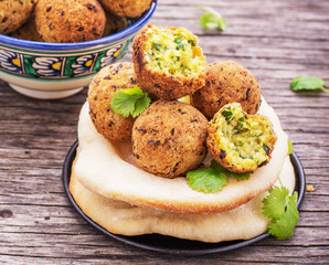 fresh falafel balls served on a wooden board