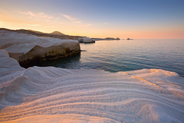 Coastal scenery with pale volcanic rocks near Sarakiniko beach in Milos island, Greece.