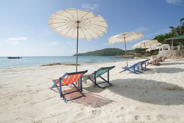 summer white beach and chairs on tropical island.