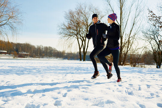Couple of runners at winter in park
