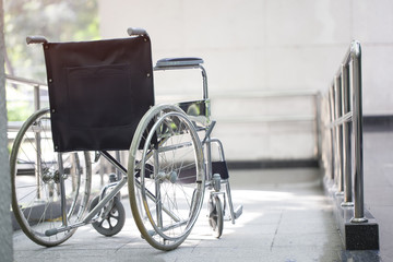 Fototapeta na wymiar Empty wheelchair parked in hospital