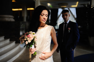 Bride and groom with a wedding bouquet in the background Interio