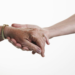 Fototapeta premium Female care worker supports the hand of a senior patient.