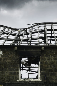 Building burnt out roof and window in the aftermath of a fire.