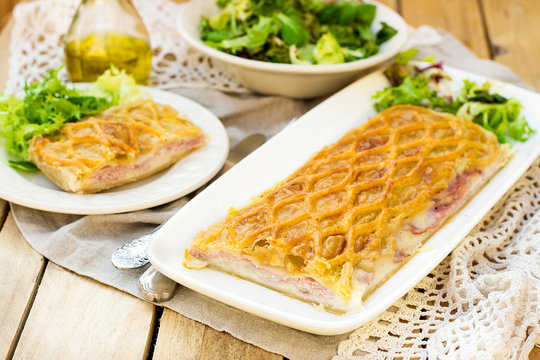 Puff pastry pasty with bechamel sauce, ham and cheese