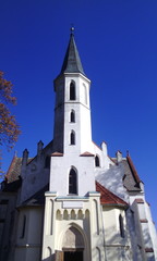 Fototapeta na wymiar White church with tower above the entrance