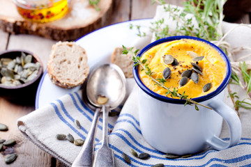 Roasted pumpkin and carrot soup with cream . 
