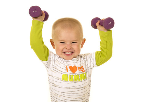 young boy holding purple weights up