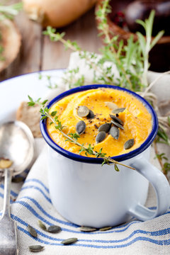 Roasted pumpkin and carrot soup with cream . 