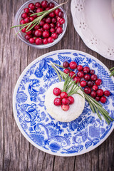 Raw vegan berry cheesecake gluten-free on a white wooden background