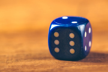 Blue dice on wooden table
