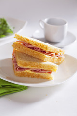 two sandwich with ham and cheese butter