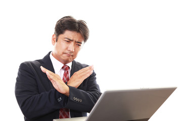 禁止の意思表示をするビジネスマン