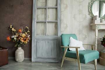 Fototapeta na wymiar Interior retro room with an armchair, flowers, door and mirror