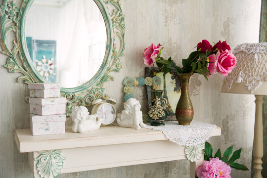 Closeup vintage interior with mirror and a table with a vase and
