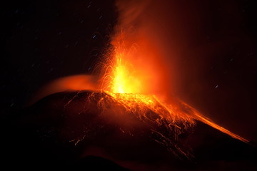A fiery volcano erupting with red lava, casting a glowing red hue over the landscape as magma and...