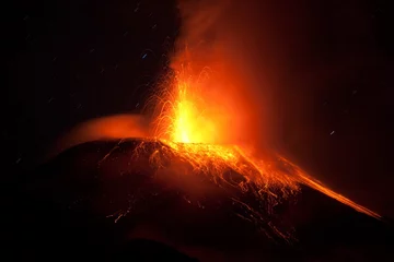 Fotobehang A fiery volcano erupting with red lava, casting a glowing red hue over the landscape as magma and dust explode into the air. © Ammit