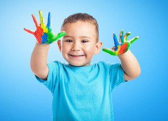 portrait of cute kid having fun with hands paint