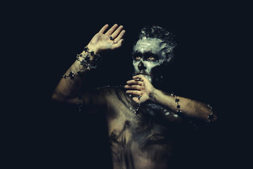 wild man with white painted face and full body black paint - obrazy, fototapety, plakaty