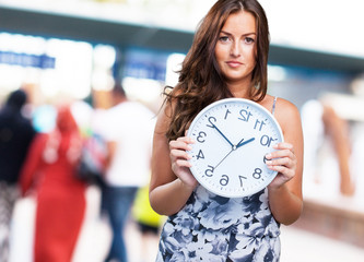 pretty woman holding a clock