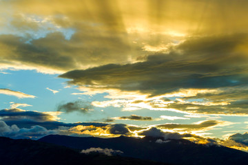 Witness the breathtaking beauty of a dramatic sunset over the majestic Andes Mountains in Ecuador,a truly awe inspiring natural spectacle.