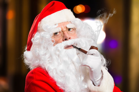 Santa Claus smoking a tobacco pipe