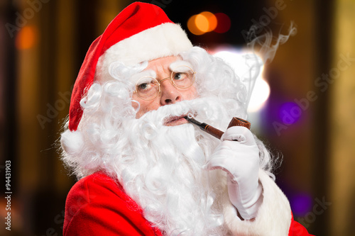 &ldquo;Santa Claus smoking a tobacco pipe&rdquo; Stock photo and royalty-free